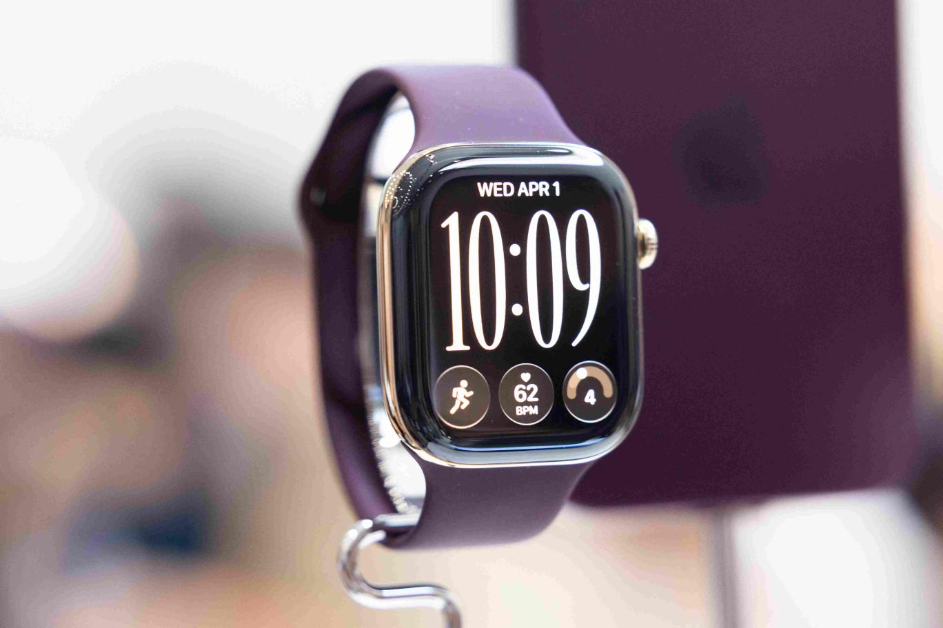 Close-up of the Apple Watch Series 12 with a purple strap on display stand at Apple Park in Cupertino.